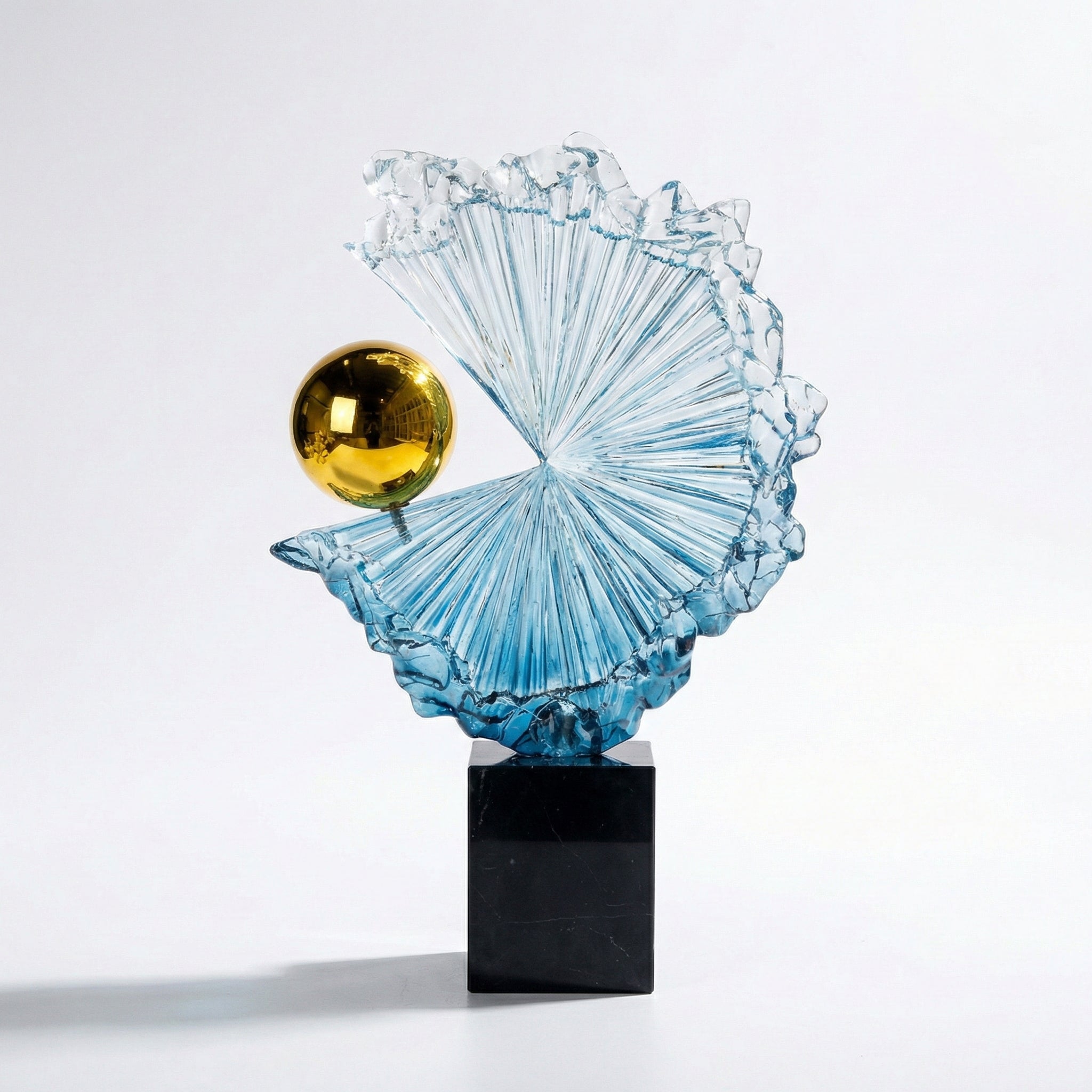 Detail view of blue textured glass and gold orb sculpture