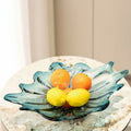 Blue glass organic leaf centerpiece bowl with fruit on marble table