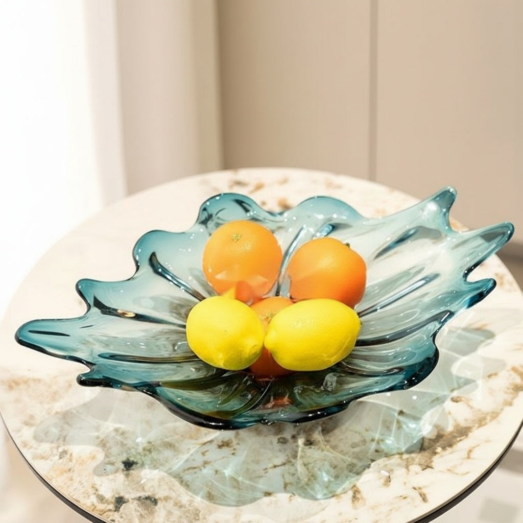 High angle view of blue glass leaf bowl on table