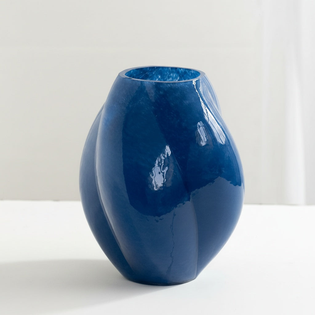 Detail view of empty blue glass spiral fluted vase