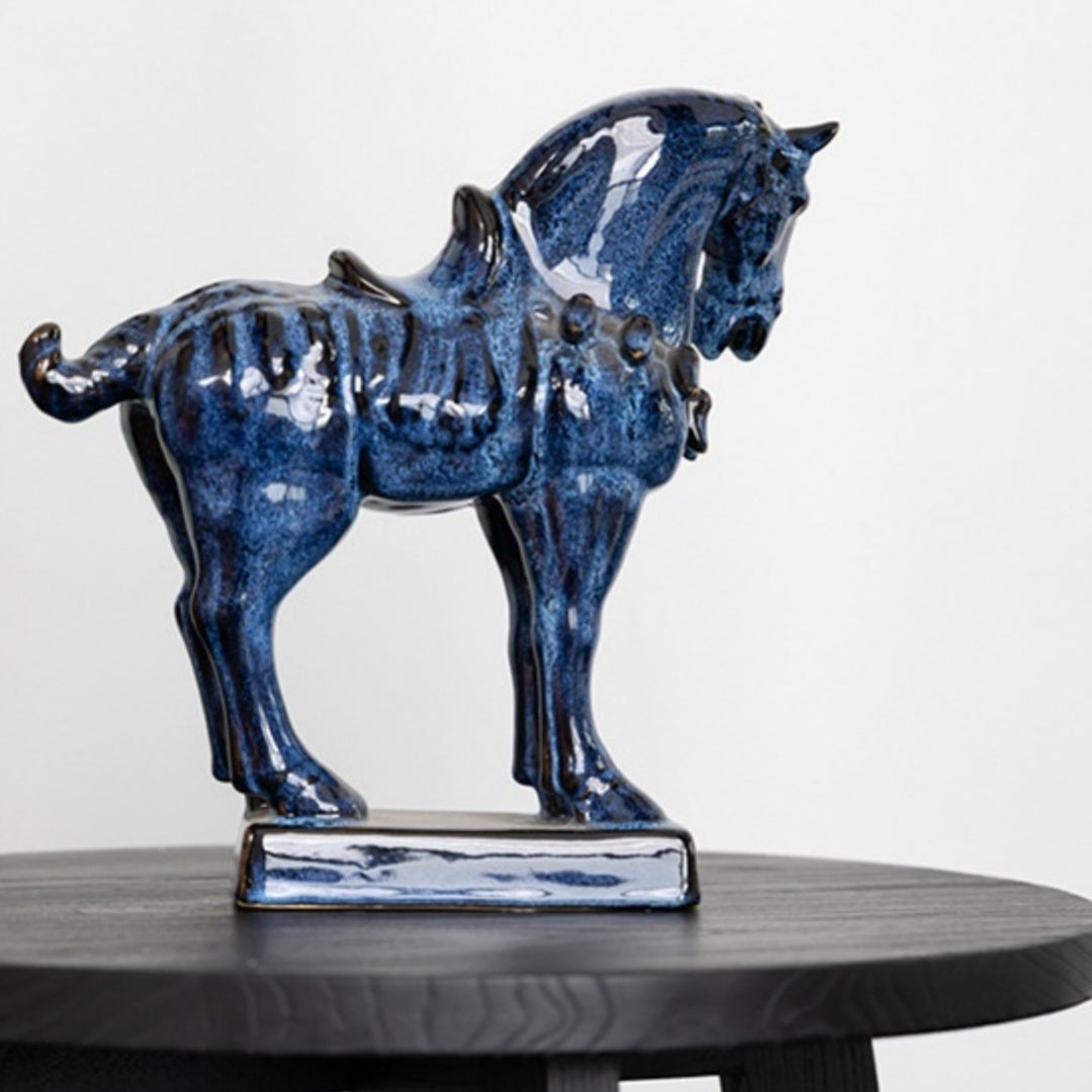 Side profile of blue glazed ceramic horse sculpture on black table