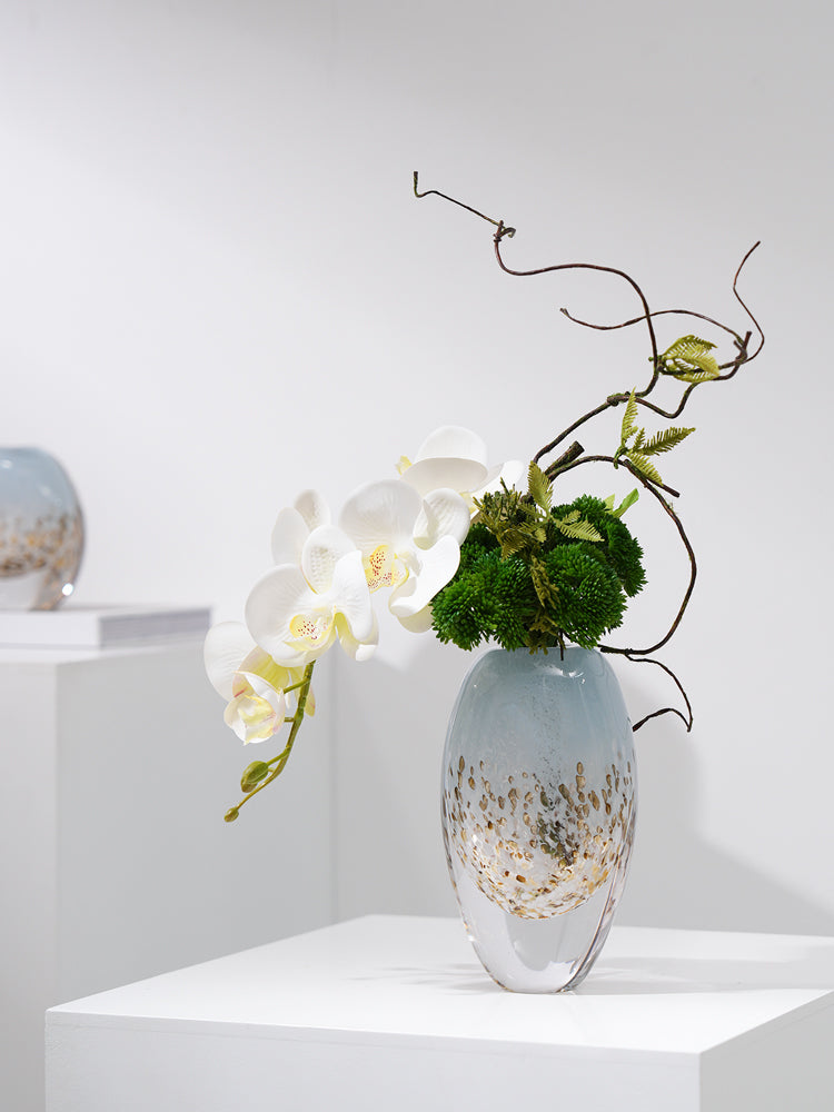 Large blue vase styled with peacock feathers