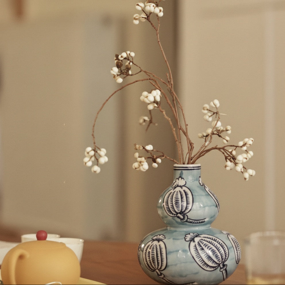 Blue patterned ceramic double gourd vase with dried flowers