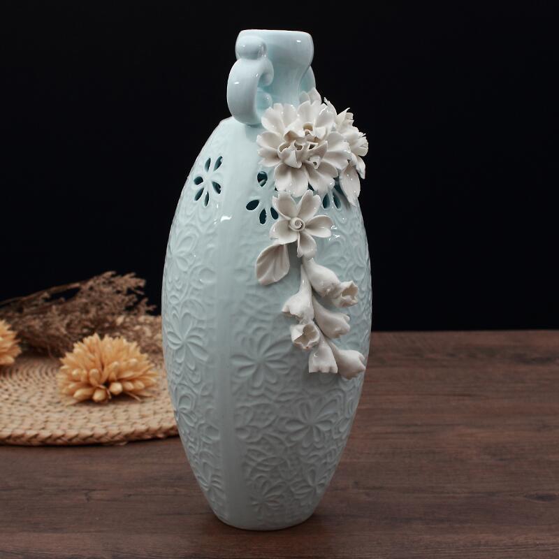 Tall pale blue ceramic vase with 3D white flowers and cutout design