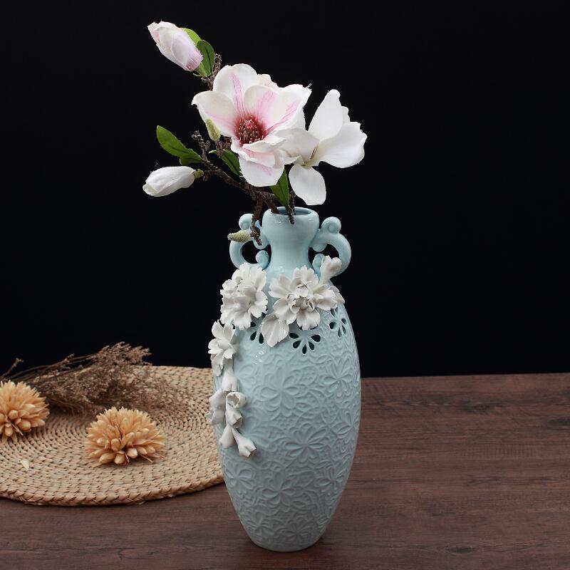 Side view of tall blue ceramic vase with floral texture