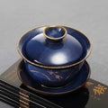 Blue porcelain lidded teacup on dark books