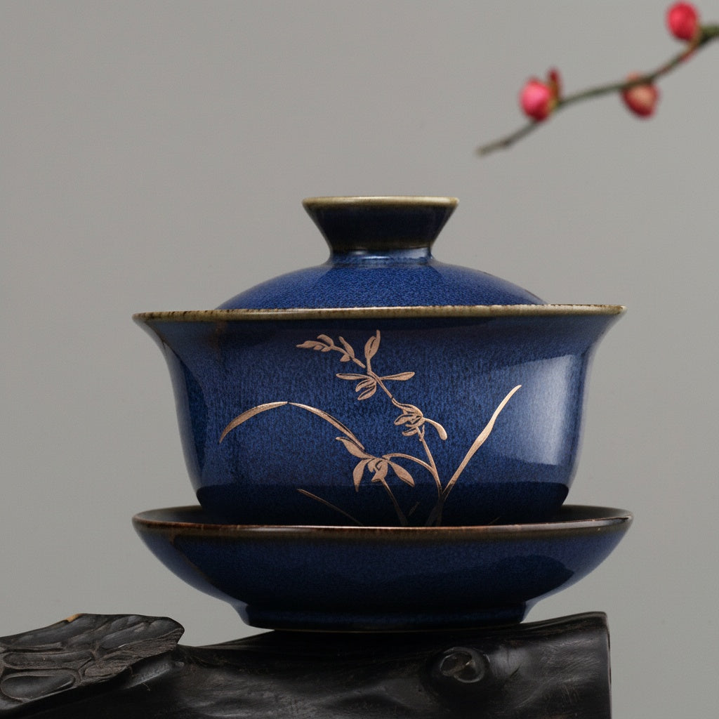 Profile view of blue teacup with gold floral design
