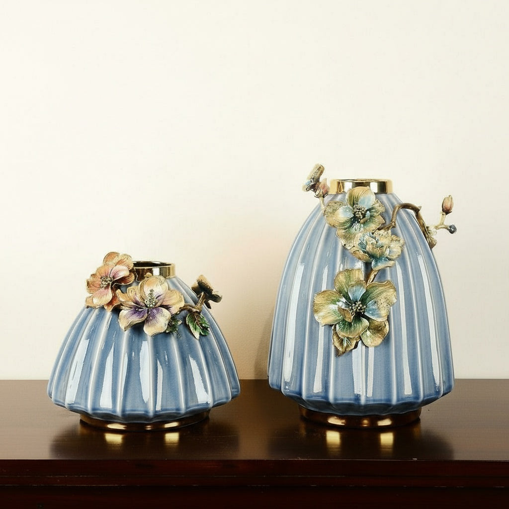 Group shot of large and medium blue ribbed ceramic vases with floral details