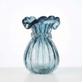 Front view of blue ribbed glass vase with ruffled rim