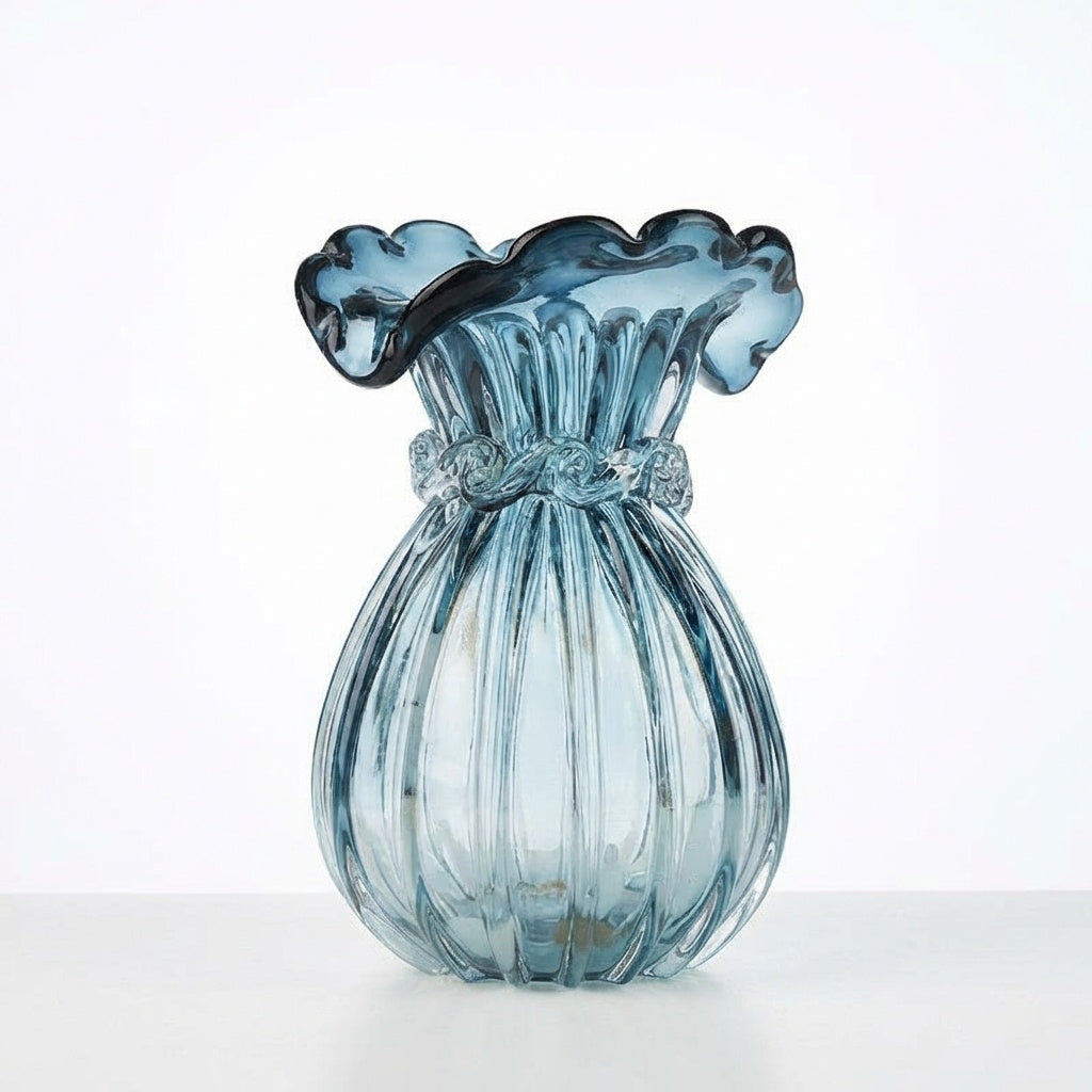 Front view of blue ribbed glass vase with ruffled rim