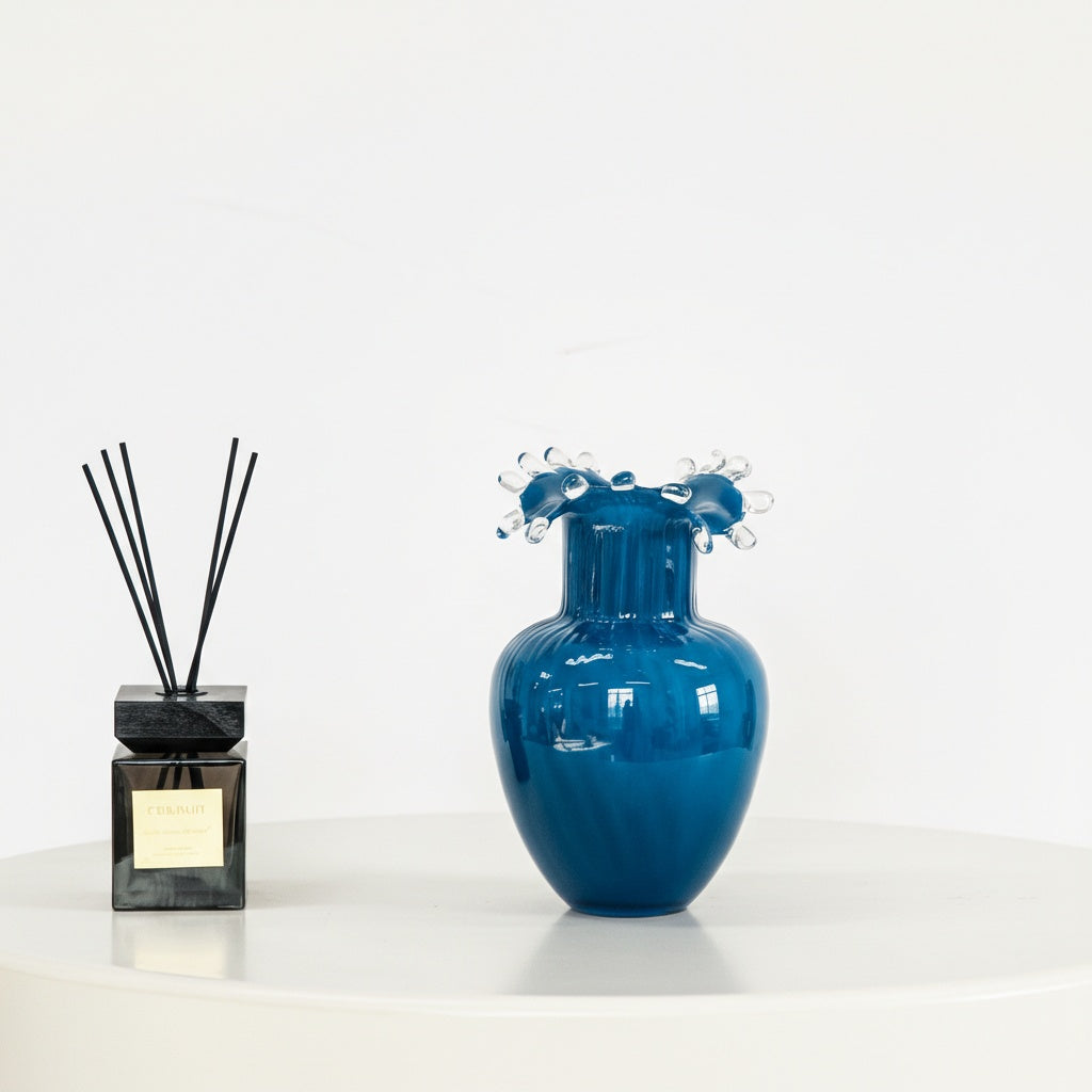 Blue ribbed glass vase with clear splash rim detail