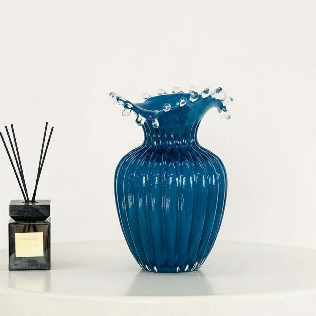 Medium blue glass vase with vertical ridges