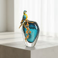 Blue seeded glass vase with enamel parrot detail front view