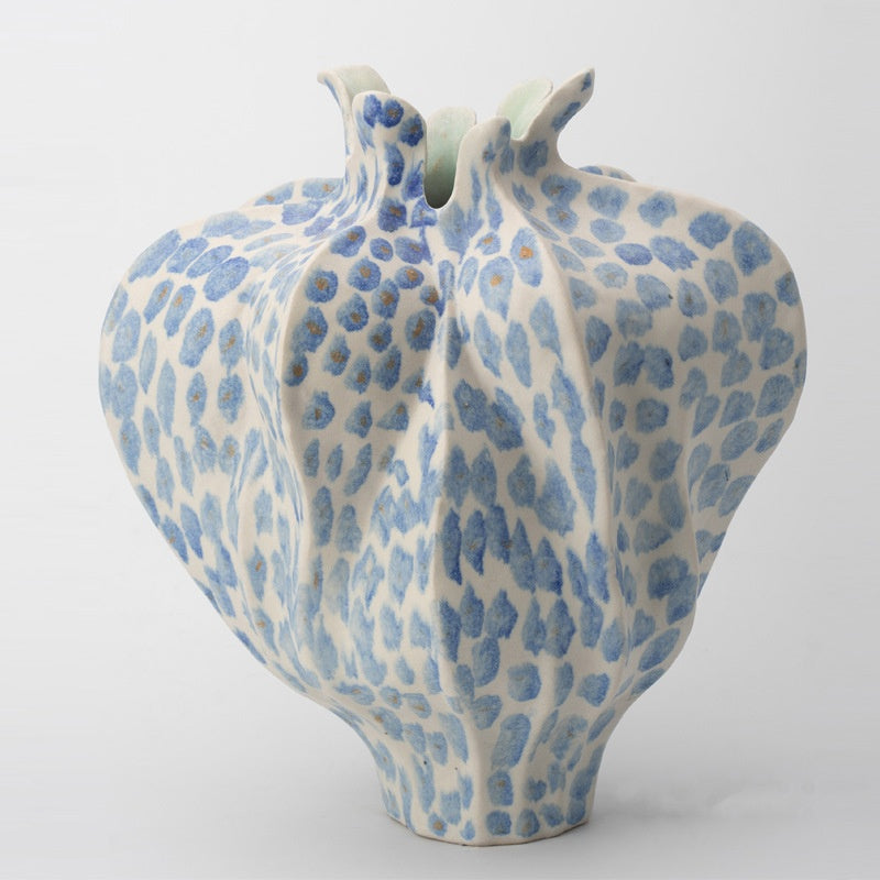 Front view of blue and white spotted ceramic pomegranate vase