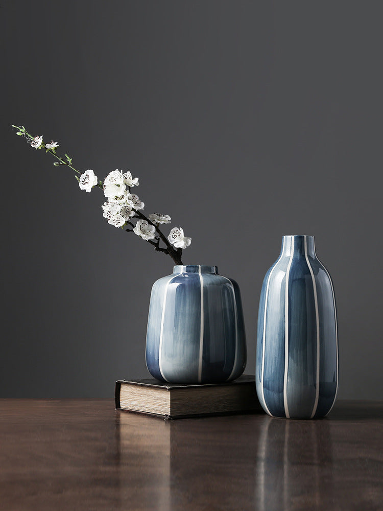 Blue and white striped ceramic vases with white cherry blossoms