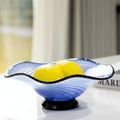 Blue swirl glass bowl with lemons on table