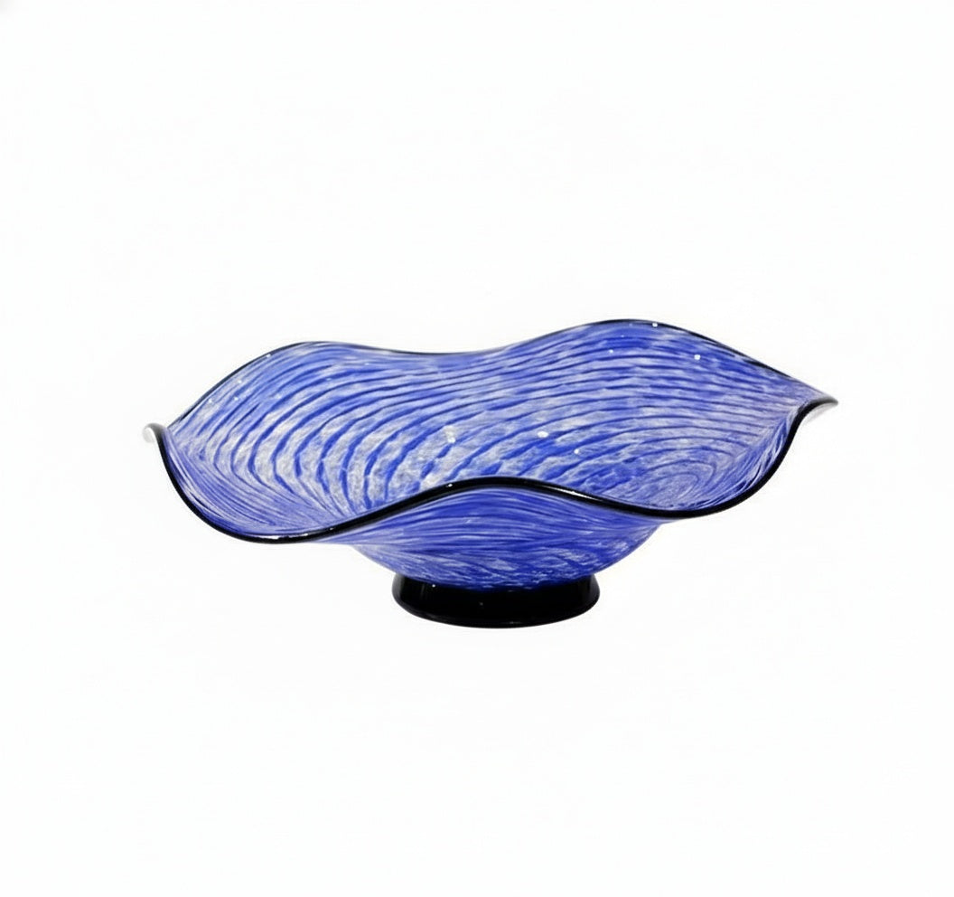 Front view of blue scalloped glass bowl on black base