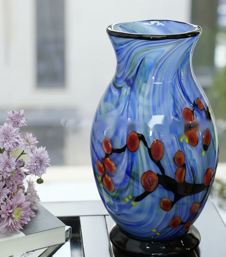 Angled view showing the curvature and floral details of the blue glass vase