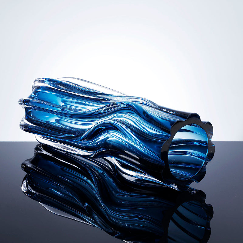 Top down perspective of scalloped rim on blue glass vase