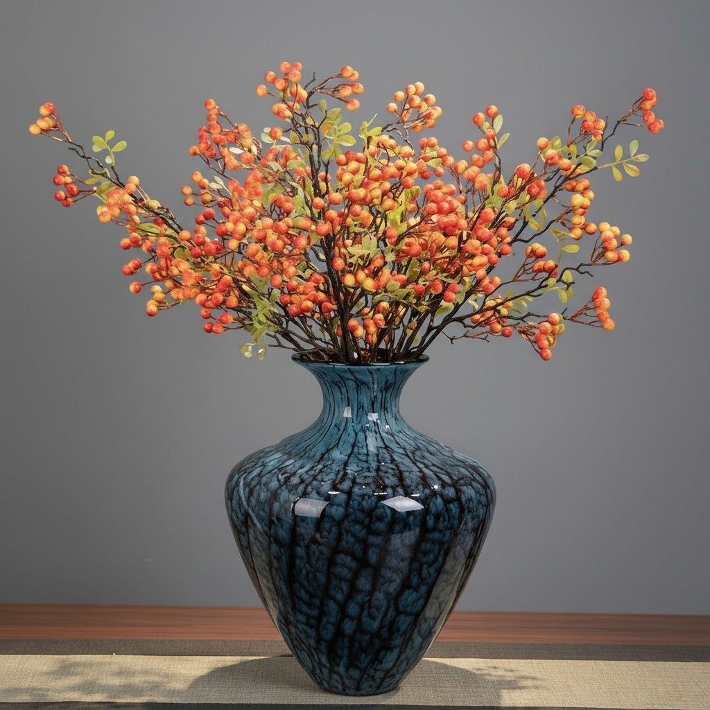 Blue veined patterned ceramic vase with artificial orange berries