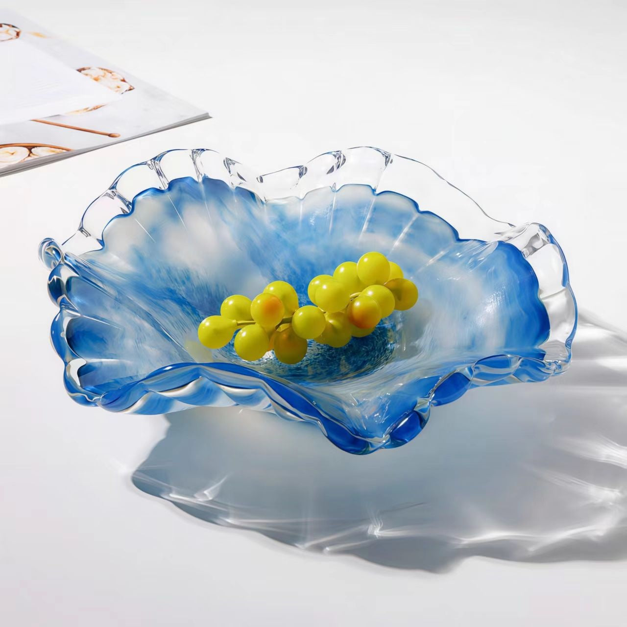 Blue and white art glass ruffled bowl with grapes