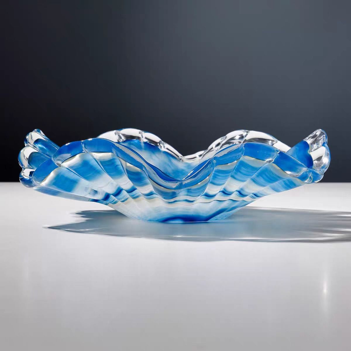 Side view of low profile blue glass centerpiece bowl