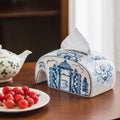Blue and white ceramic arched tissue box cover on wooden table