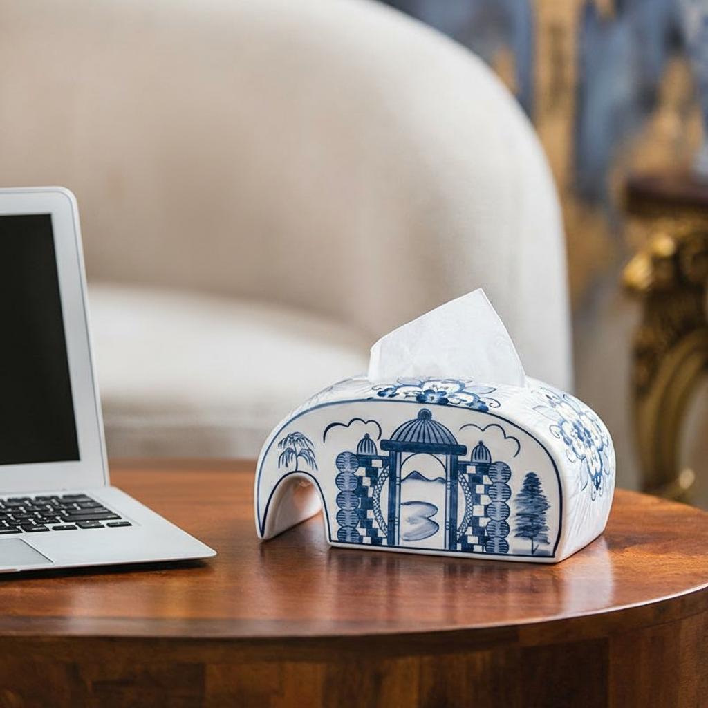 Ceramic tissue box cover on desk next to laptop