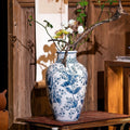 Styled blue and white porcelain vase in rustic luxury setting