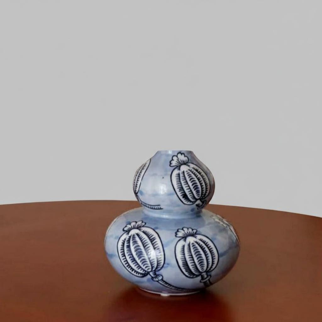 Close up of empty blue and white ceramic vase showing double gourd shape