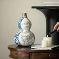 Blue and white ceramic double gourd vase on wooden table