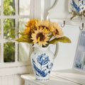 Blue and white ceramic fluted vase with floral design