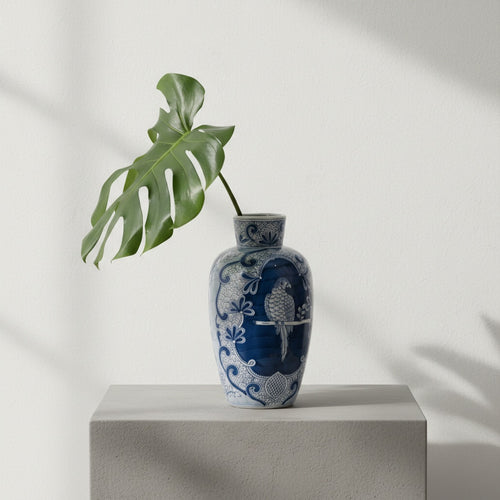 Front view of blue and white ceramic vase with parrot motif