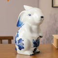 Standing ceramic rabbit statue with blue floral details