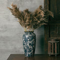 Large blue and white ceramic vase with dried pampas grass
