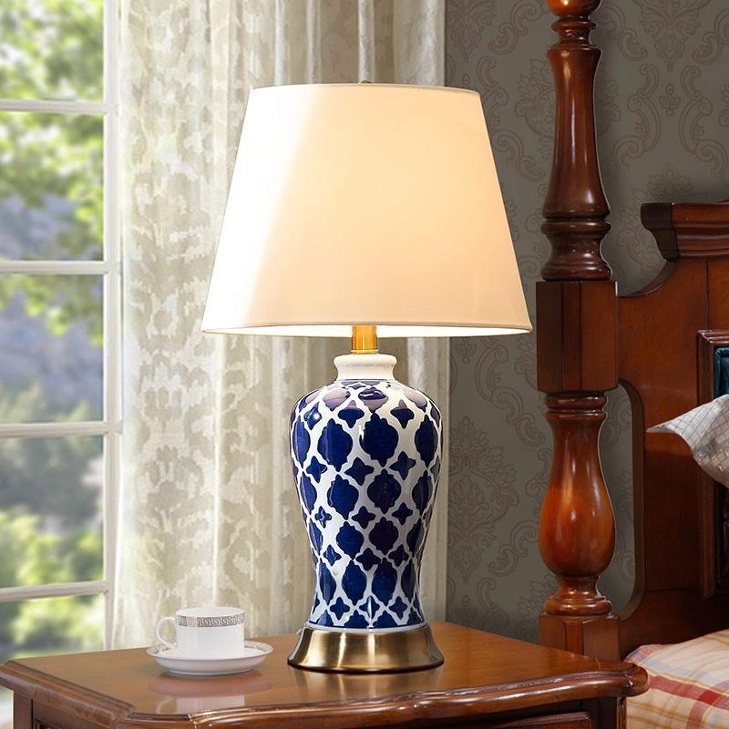 Lit blue and white patterned lamp in living room setting