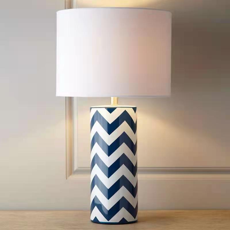 Front view of blue and white chevron ceramic table lamp with white shade