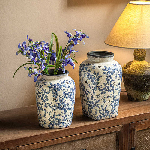 Blue and white porcelain vase with flowers on wooden console