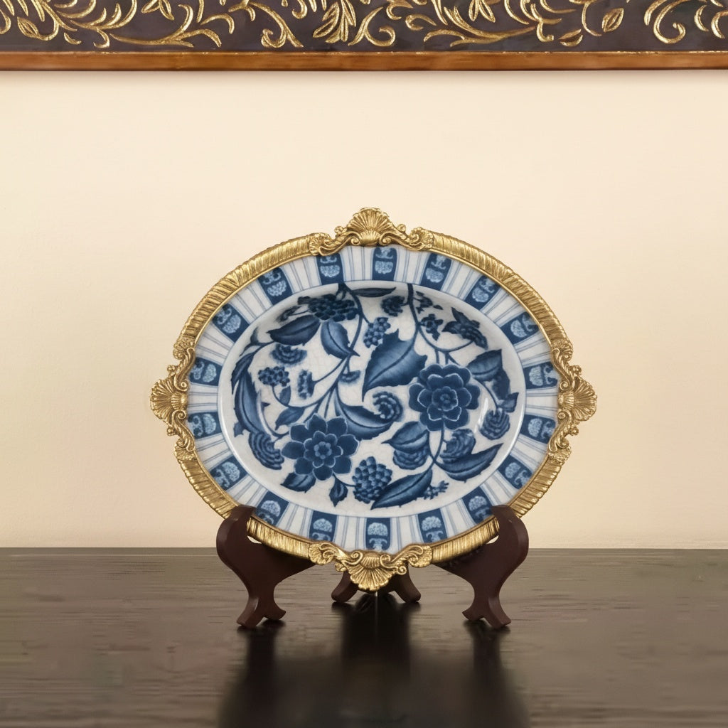 Front view of blue and white ceramic bowl with brass rim on display stand