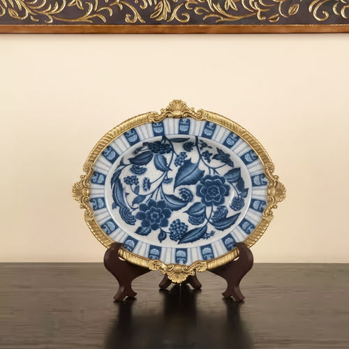 Front view of blue and white ceramic bowl with brass rim on display stand
