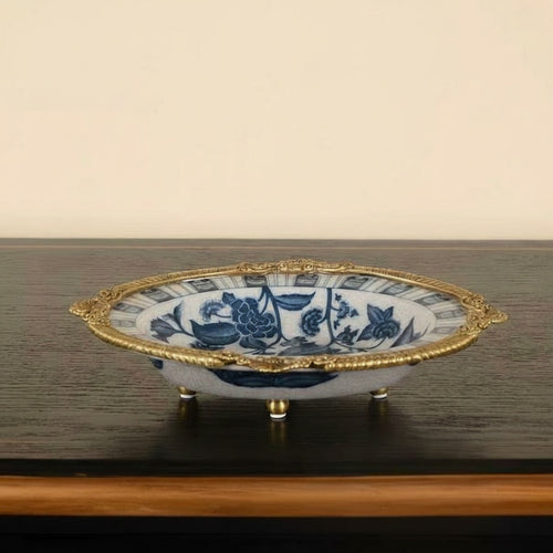 Side profile of decorative bowl showing brass rim and feet details