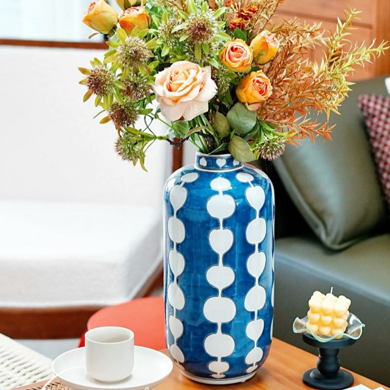 Blue and white geometric porcelain vase with fresh flowers on table
