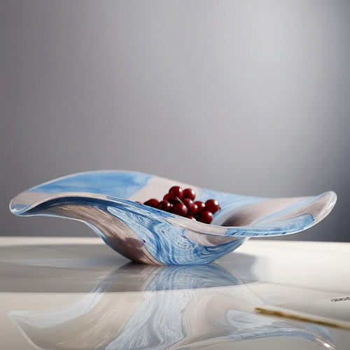 Side view of blue and white marbled glass centerpiece bowl with flowing wavy edges