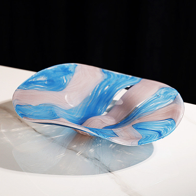Close angled view of marbled blue and white glass bowl highlighting organic wave design