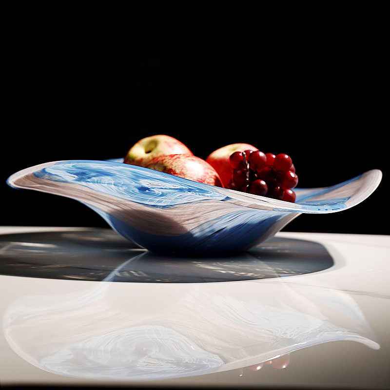 Side view of blue and white marbled glass bowl with fruit