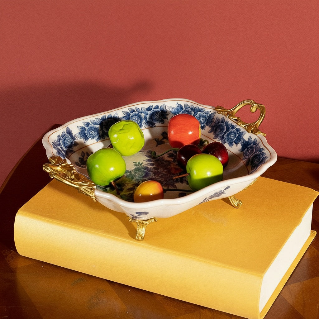 Blue and white porcelain centerpiece tray with brass handles holding fruit