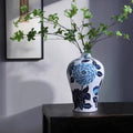 Blue and white porcelain vase with floral design on table