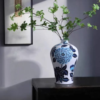 Blue and white porcelain vase with floral design on table