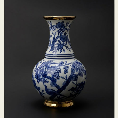 Full view of blue and white floral vase with gold accents on dark background