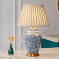 Front view of blue and white porcelain table lamp with pleated shade